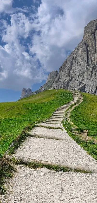 Vibrant green path leading to a rocky mountain under a cloudy sky.