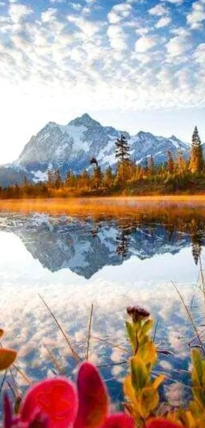 Serene mountain reflected in a tranquil lake with vibrant skies and colorful foreground.