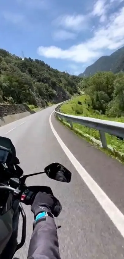 Motorcycle ride through scenic mountain road with lush green landscape.