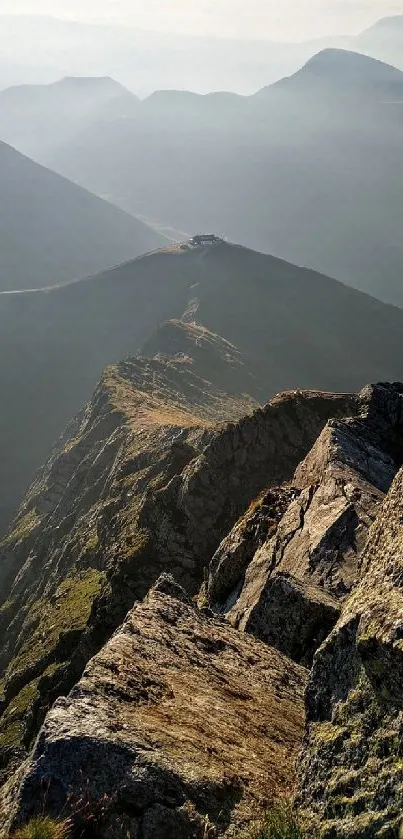 Breathtaking view of a mountain ridge with serene, misty peaks in the background.