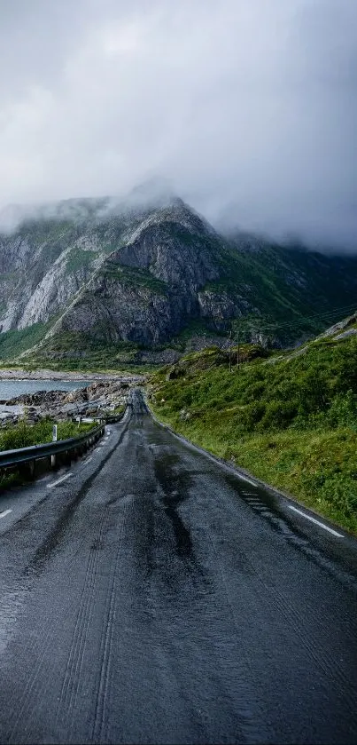 Scenic road through misty mountains with lush green landscape.