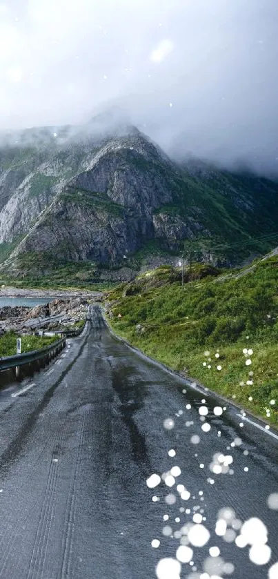 Mountain road with lush greenery and cloudy sky.