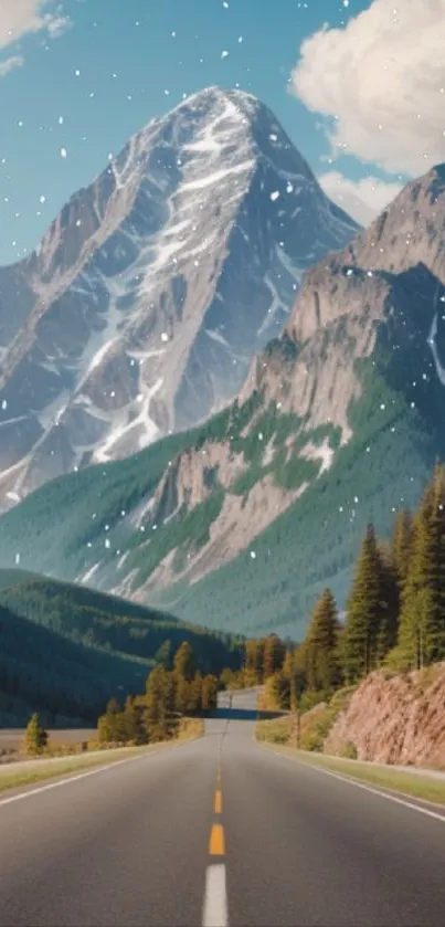 Scenic mountain road with snow-capped peaks under a blue sky wallpaper.