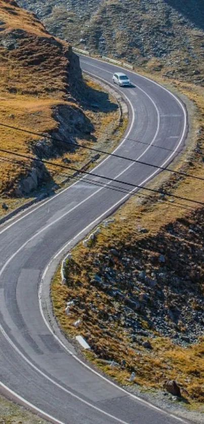 Winding road on a scenic mountain landscape wallpaper.