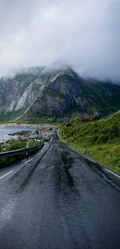 A scenic mountain road with misty clouds and rocky cliffs.