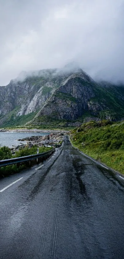 Scenic road leading towards misty mountains.