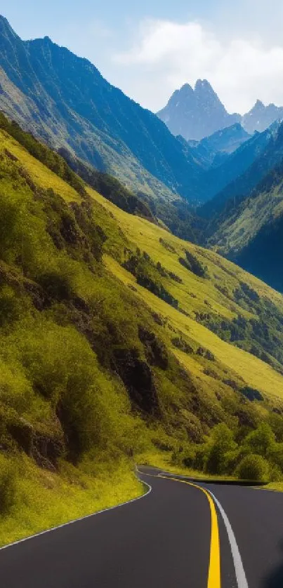 Green mountains with a road under a blue sky, offering a serene view.