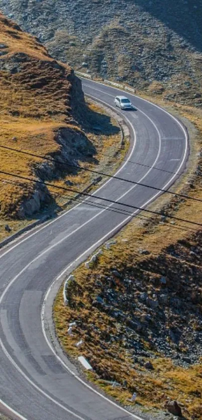 Winding mountain road with a car on a scenic landscape mobile wallpaper.