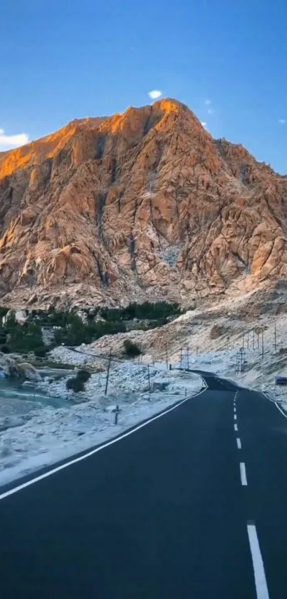 Scenic road through mountains with a blue sky.