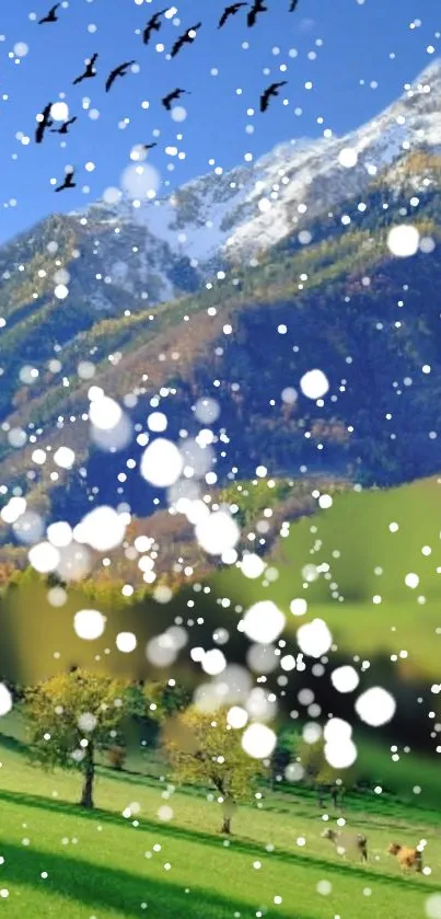 Snowy mountain landscape with green valley and falling snow.