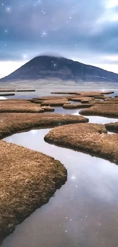 Scenic mountain landscape with a winding stream under a dynamic sky.