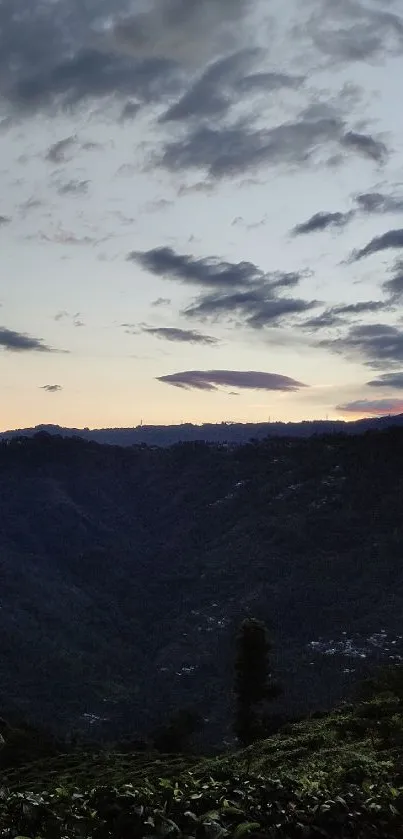 Scenic mountain view at sunset with cloud formations.