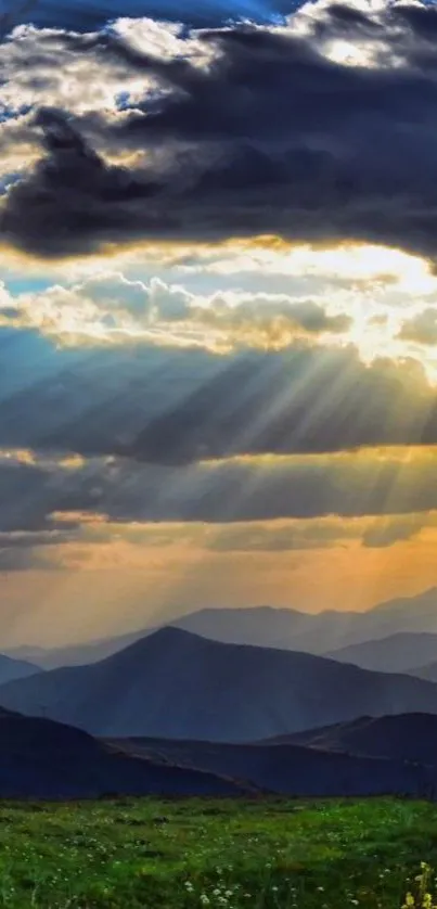 Majestic mountains under a sunset sky with dramatic clouds and sun rays.