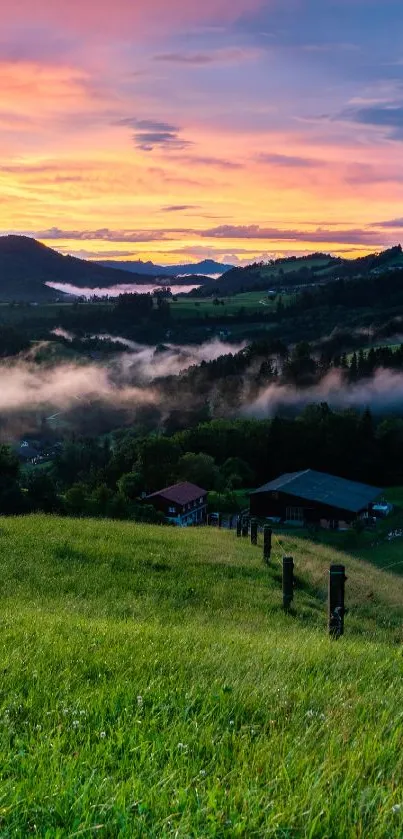 Scenic view of a mountain sunset with misty valleys and lush green fields.