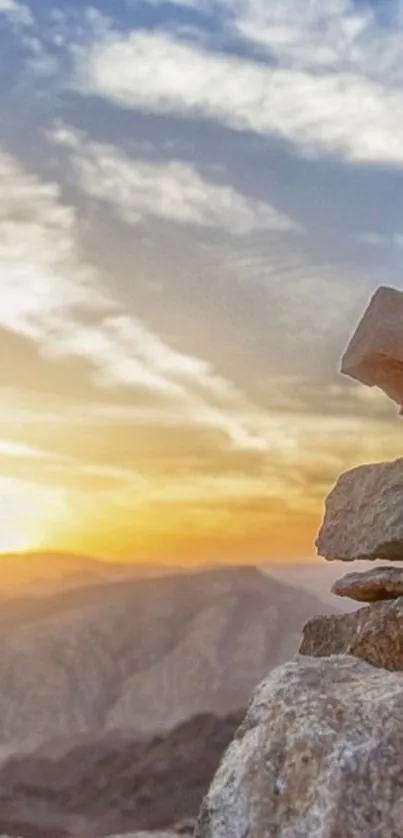 Stunning sunset over mountains with rocky foreground.