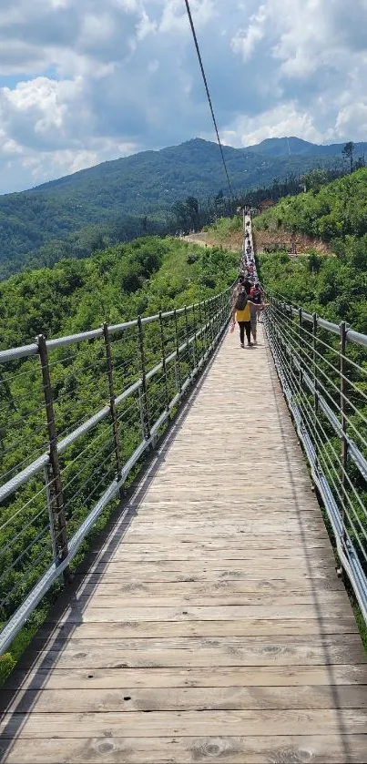 Suspension bridge over lush green mountains.