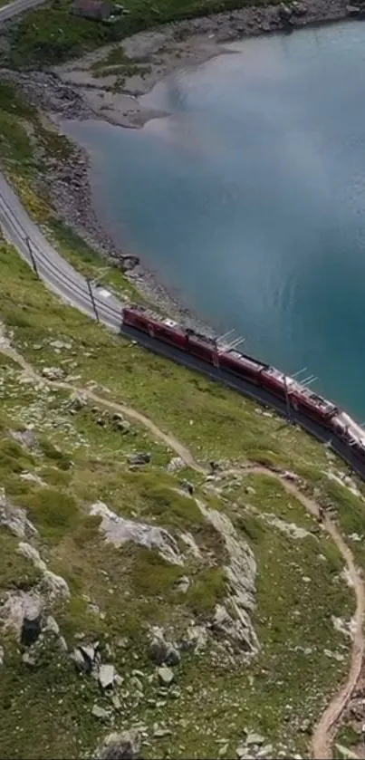 A train travels through mountain terrain beside a scenic azure lake.