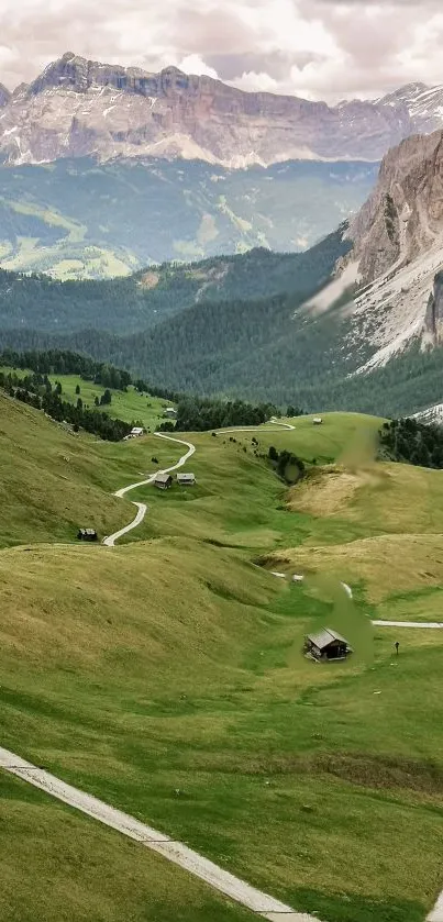 Stunning view of a lush mountain valley with winding paths and majestic peaks.