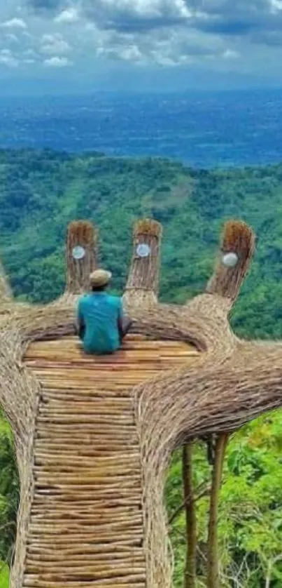 Man sitting on bamboo platform overlooking lush green hills.