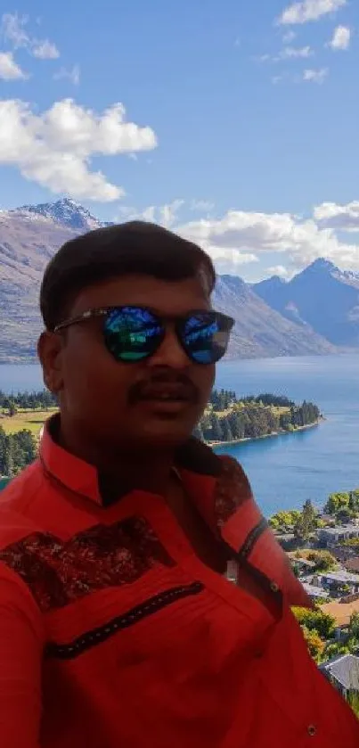 Man in sunglasses with scenic lake and mountains