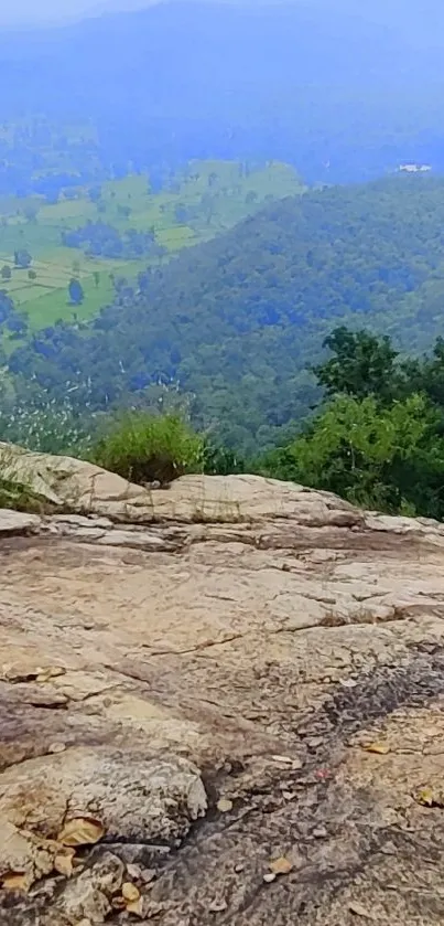 Majestic mountain view with lush greenery and rocky outcrop.