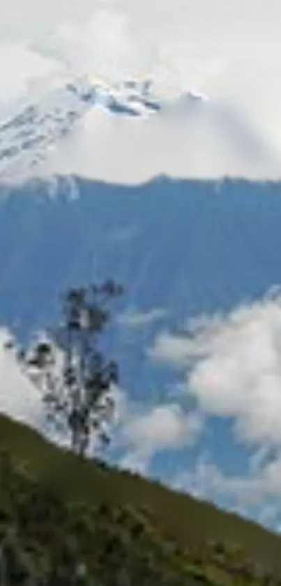 Snow-capped mountain with greenery and clouds.