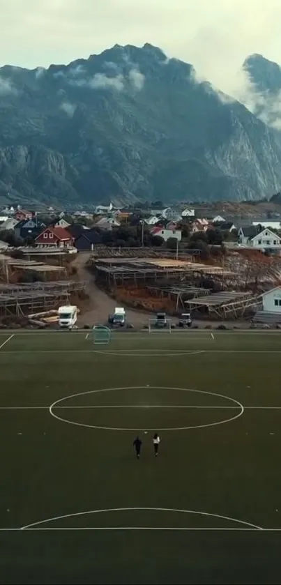 Aerial view of mountain village with football field.