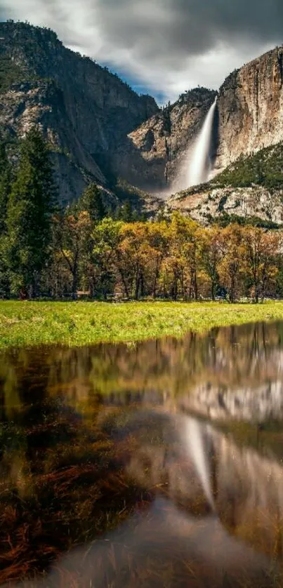 Waterfall against mountains with reflective lake.