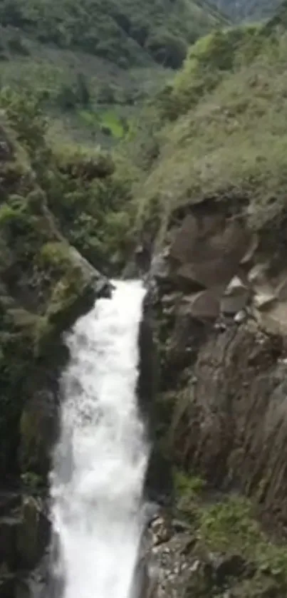 Mountain waterfall cascading through lush greenery.