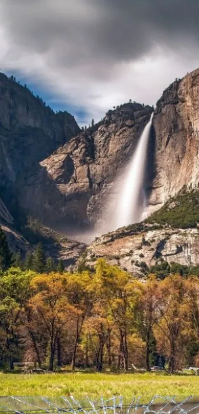 Majestic waterfall cascading down mountains surrounded by lush greenery.