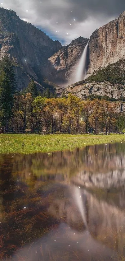 Waterfall amidst lush green mountains and valley reflection.