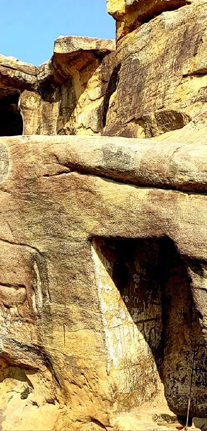 Mobile wallpaper of a scenic natural rock formation under blue skies.