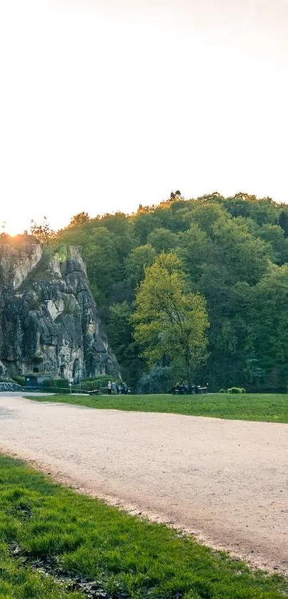 Scenic path with rock formations and greenery under morning light.