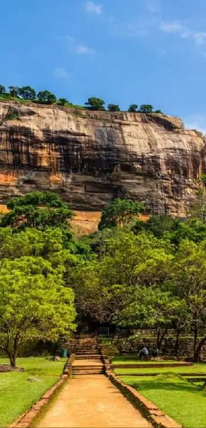 Vibrant rock formation with lush greenery and clear skies in the background.