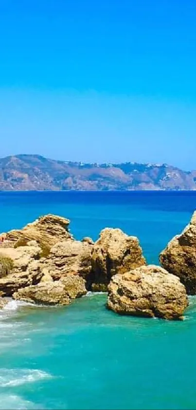 Scenic view of ocean cliffs with clear blue waters and sky.