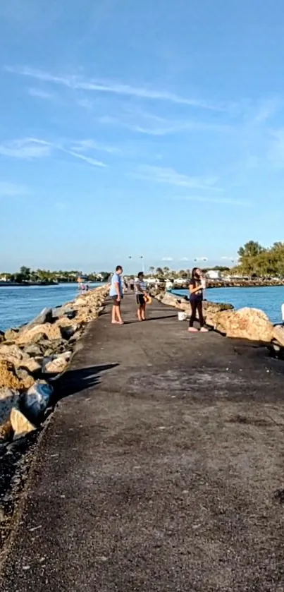 Scenic pathway along the ocean under a clear blue sky.