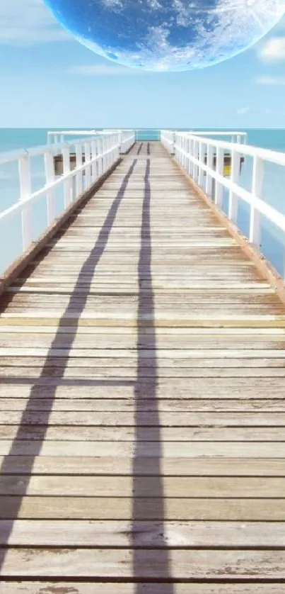 Wooden pier stretching into blue ocean with a clear sky overhead.