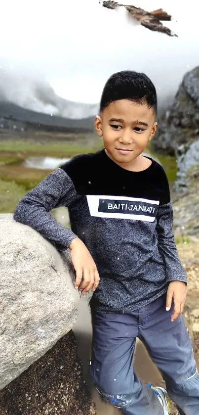 Boy leaning on rock in scenic outdoor setting, perfect for nature wallpaper.