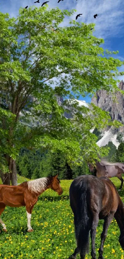 Horses grazing in a vibrant meadow with mountains and a blue sky.