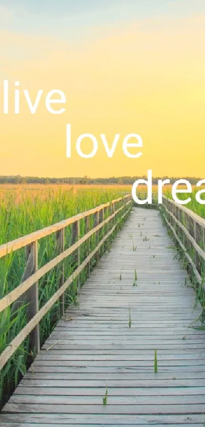 Scenic wooden pathway with 'live love dream' at sunset.