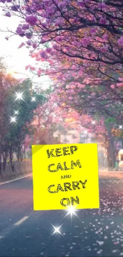 Serene road with pink blossom trees and a motivational sign.