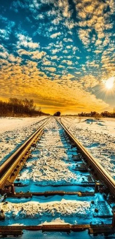 Railway track in winter under a vibrant sunset sky with snow.