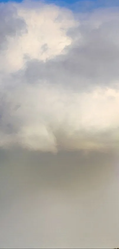 A vivid rainbow over a serene countryside under a dramatic cloudy sky.