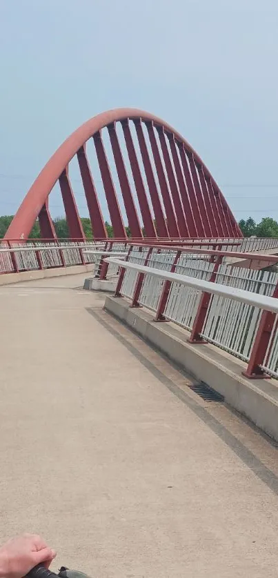 A scenic red bridge under a clear sky, suitable for mobile wallpaper.