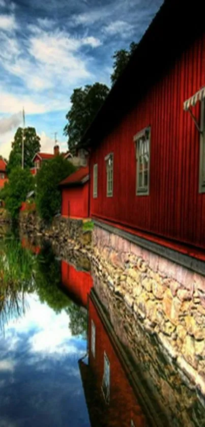 Red house reflected in calm waters under a dramatic sky.