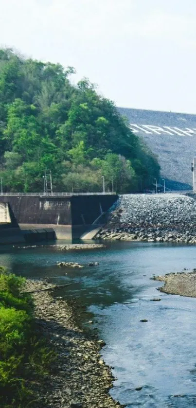 Peaceful river landscape with a dam and lush greenery.