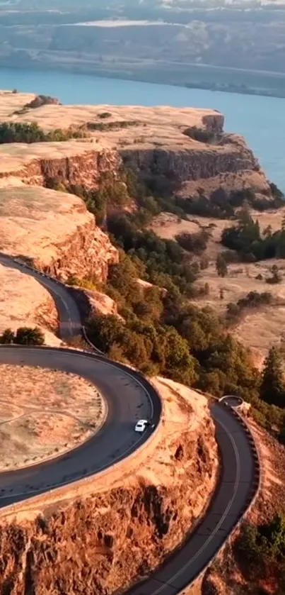 Scenic winding road through a beautiful river canyon landscape at sunset.