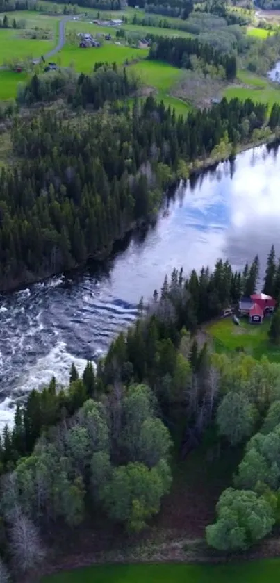 Aerial view of a river flowing through lush trees and greenery with a small cabin nearby.