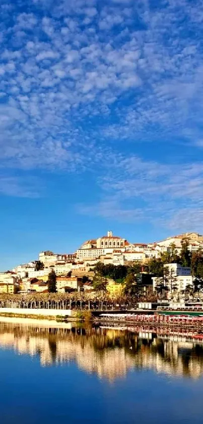 Scenic view of city by river with reflection and blue sky.