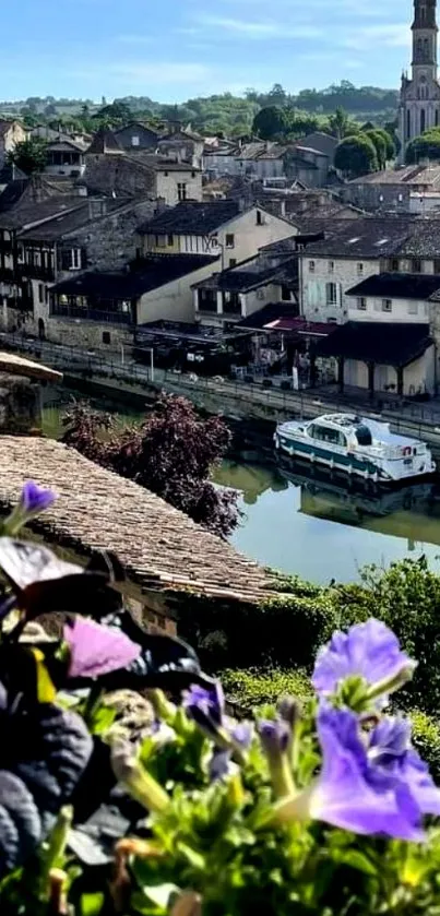 Scenic view of a riverside town with flowers and historic buildings.